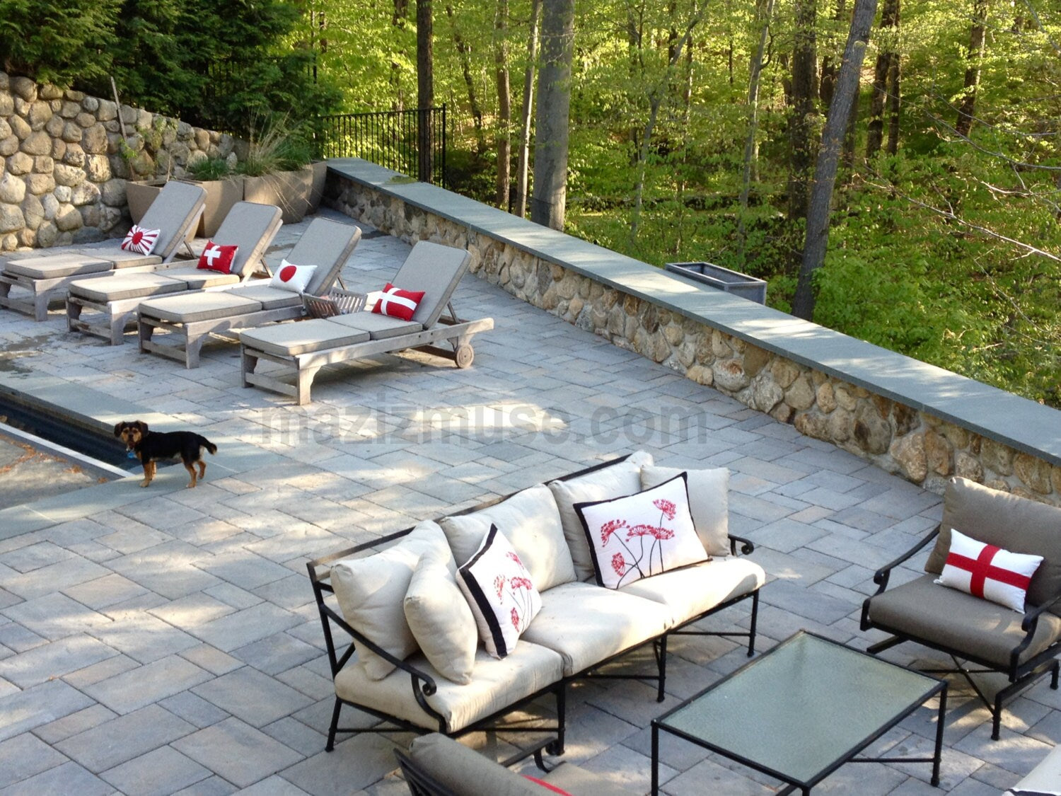 sunbrella pillows on outdoor lounge chairs in a variety of country flag designs