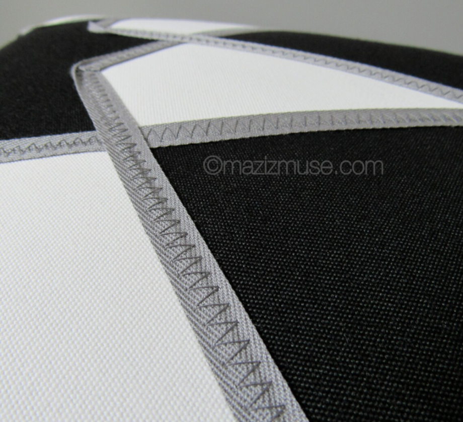 black and white sunbrella outdoor pillow showing grey trim detail and stitiching