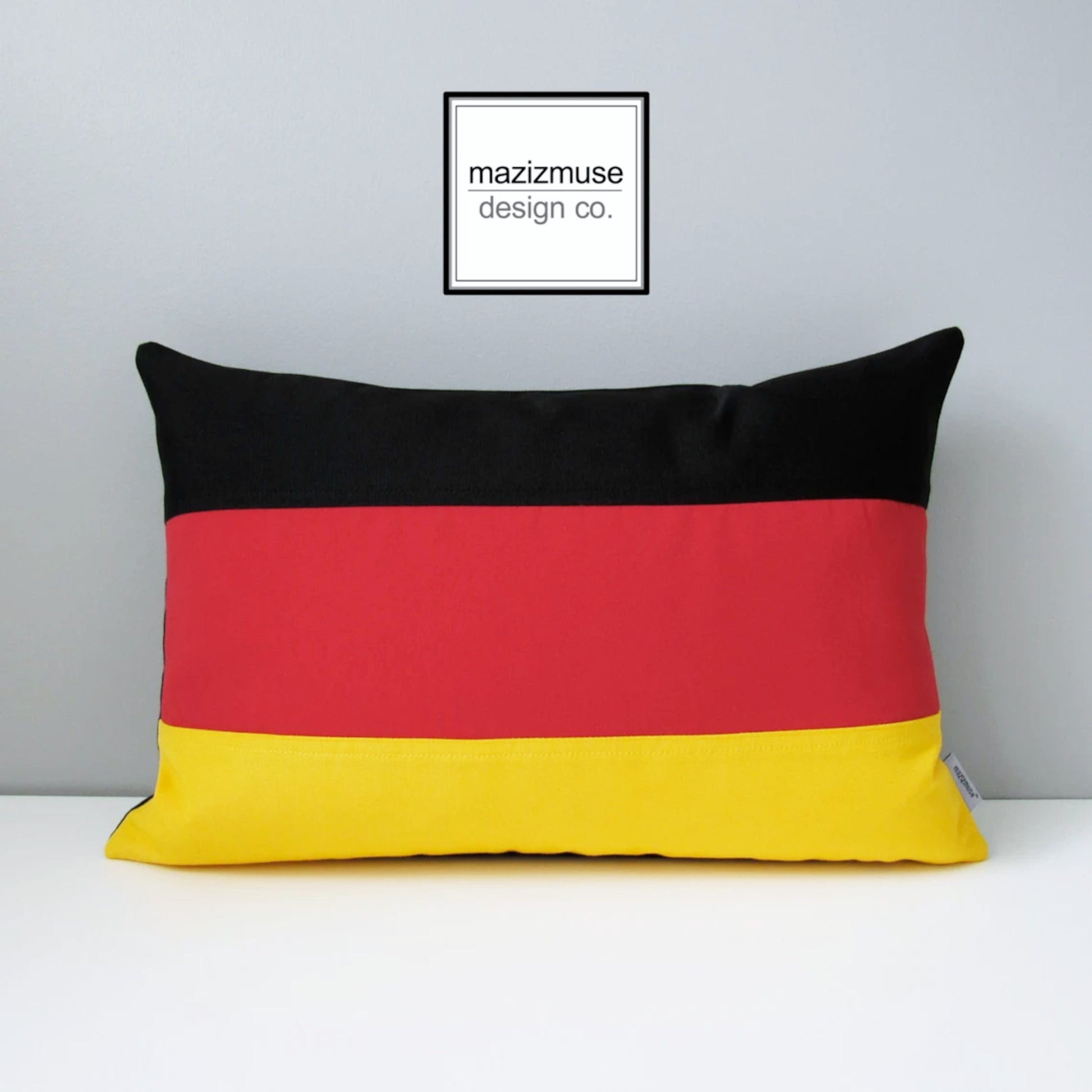decorative german flag pillow with red yellow black sunbrella fabric. 