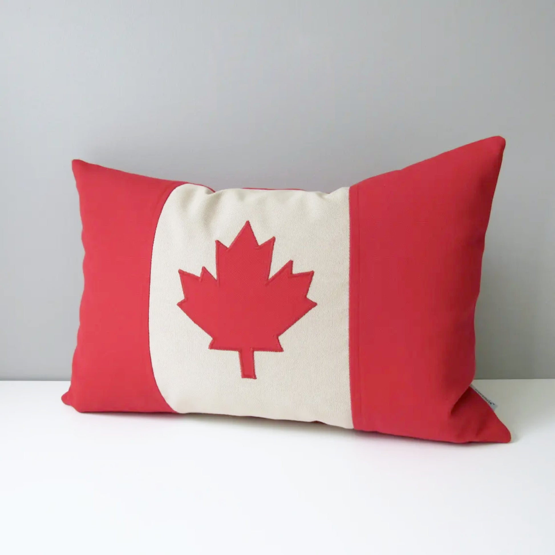 canada flag Pillow with a red and white maple leaf on a gray background