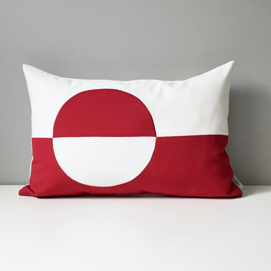 Red and white Greenland flag pillow on a gray background