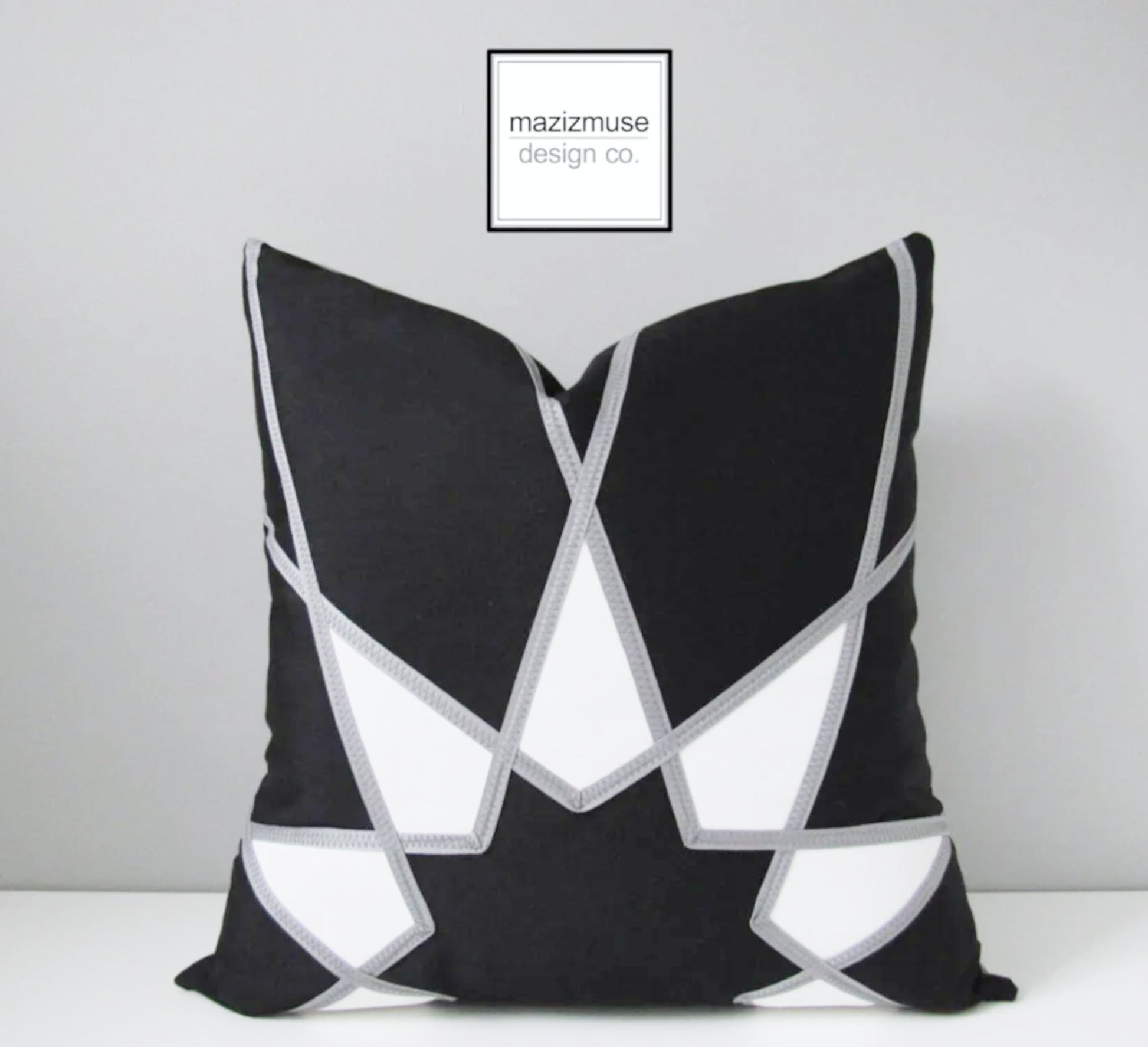 decorative black and white outdoor pillow crafted in sunbrella fabric and grey trim detail by mazizmuse