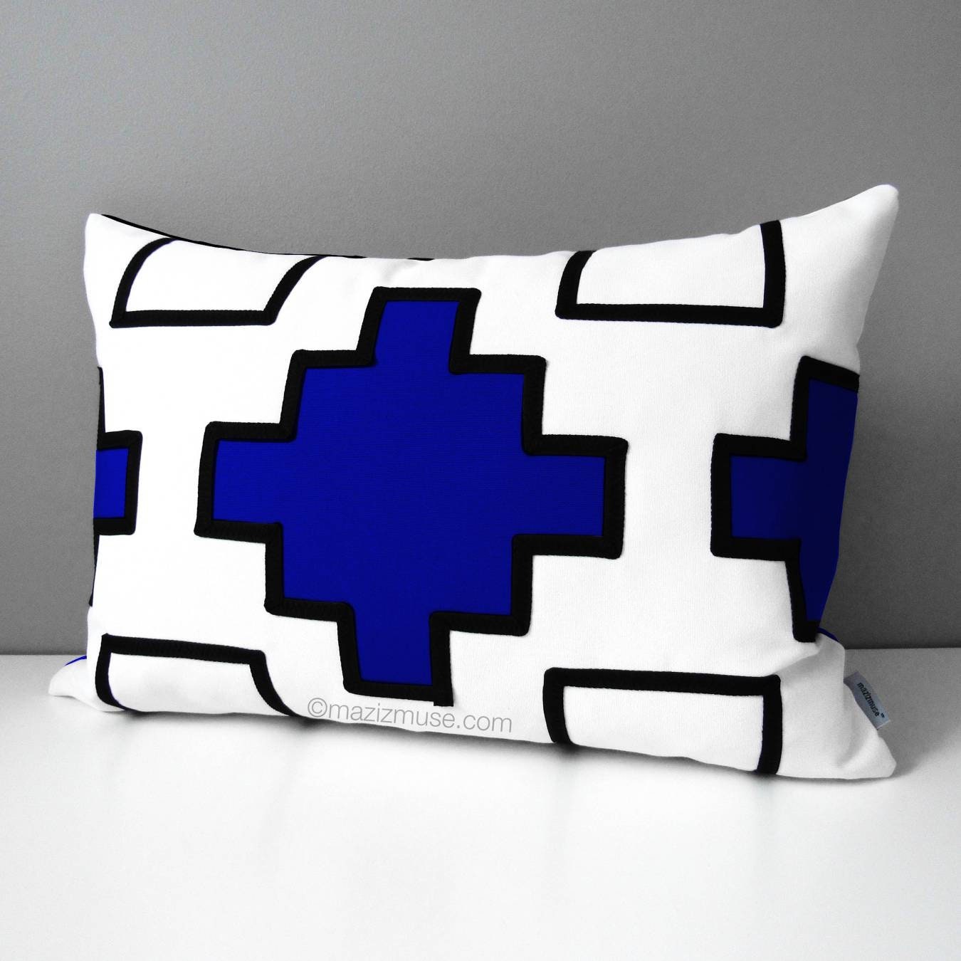 modern black and white geometric sunbrella pillow with cobalt blue aztec inspired design