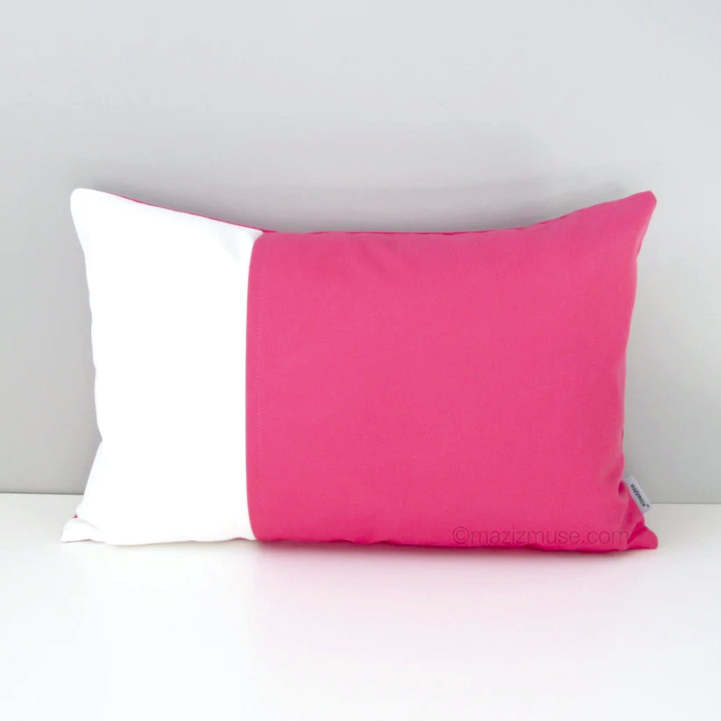 hot pink and white colorblock outdoor pillow in sunbrella fabric for pool, patio and porch seating and home decor