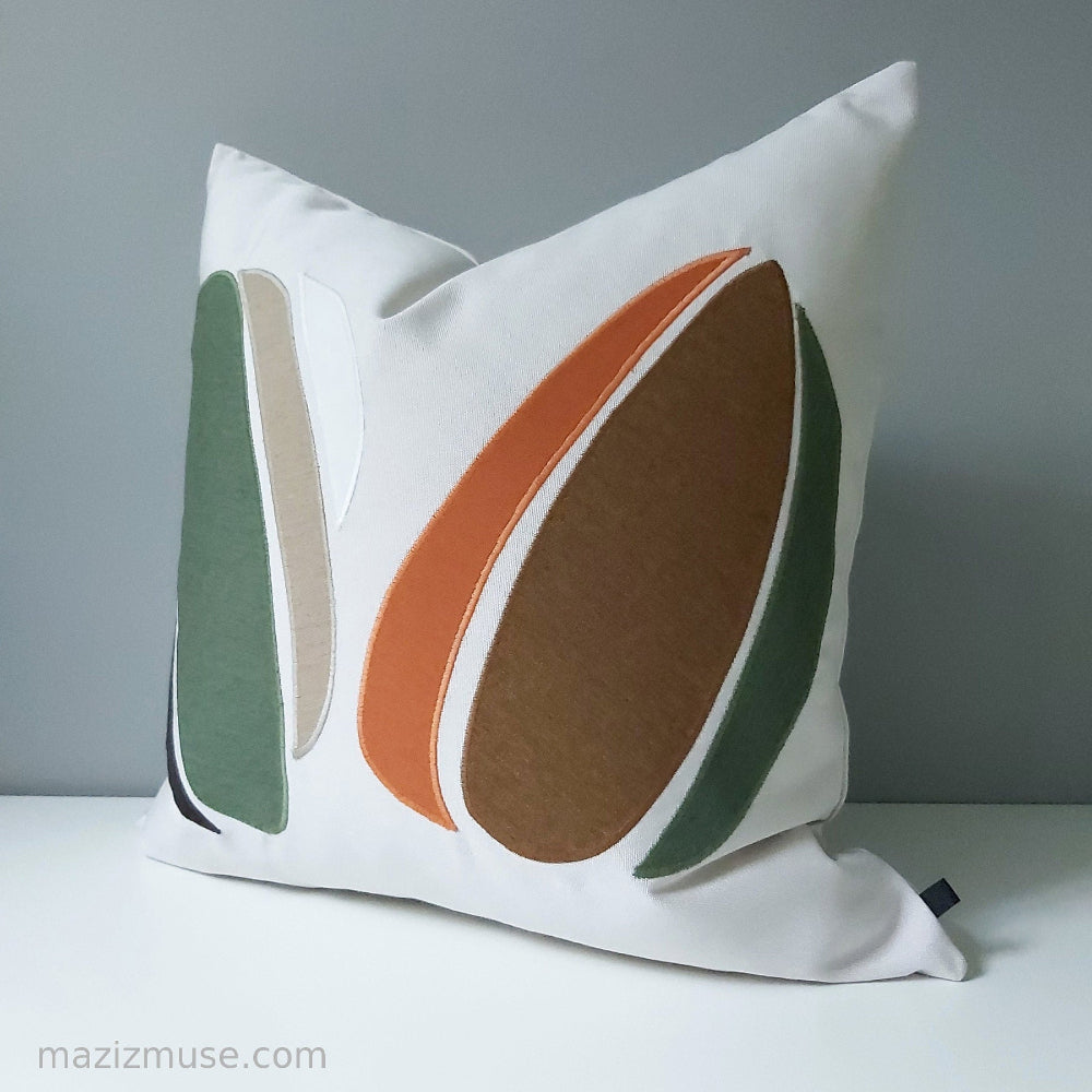 abstract outdoor pillow with rust orange and green sunbrella