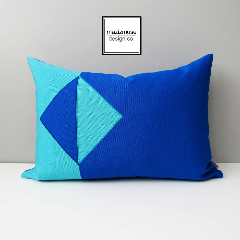 outdoor pillow in two shades of sunbrella blues - aruba and pacific.  a simplistic geometric design ideal for modern patio accents