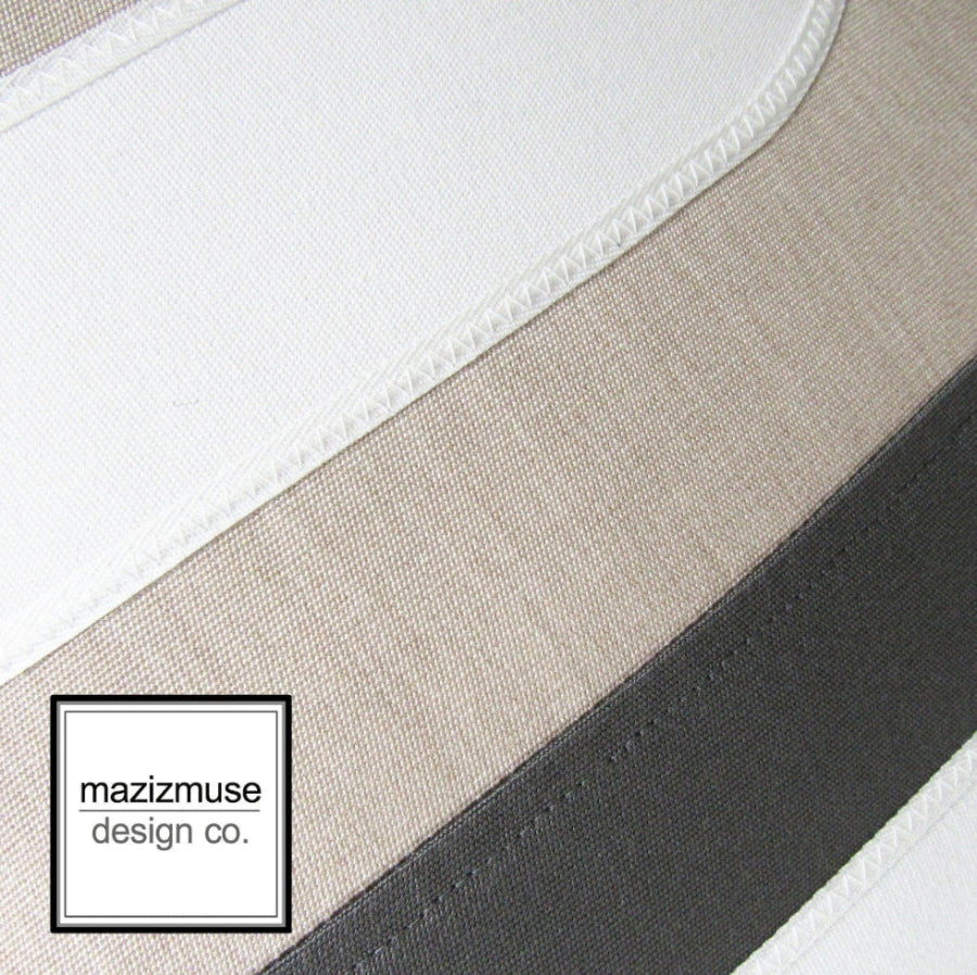 close up of flax sunbella color with charcoal grey and white applique
