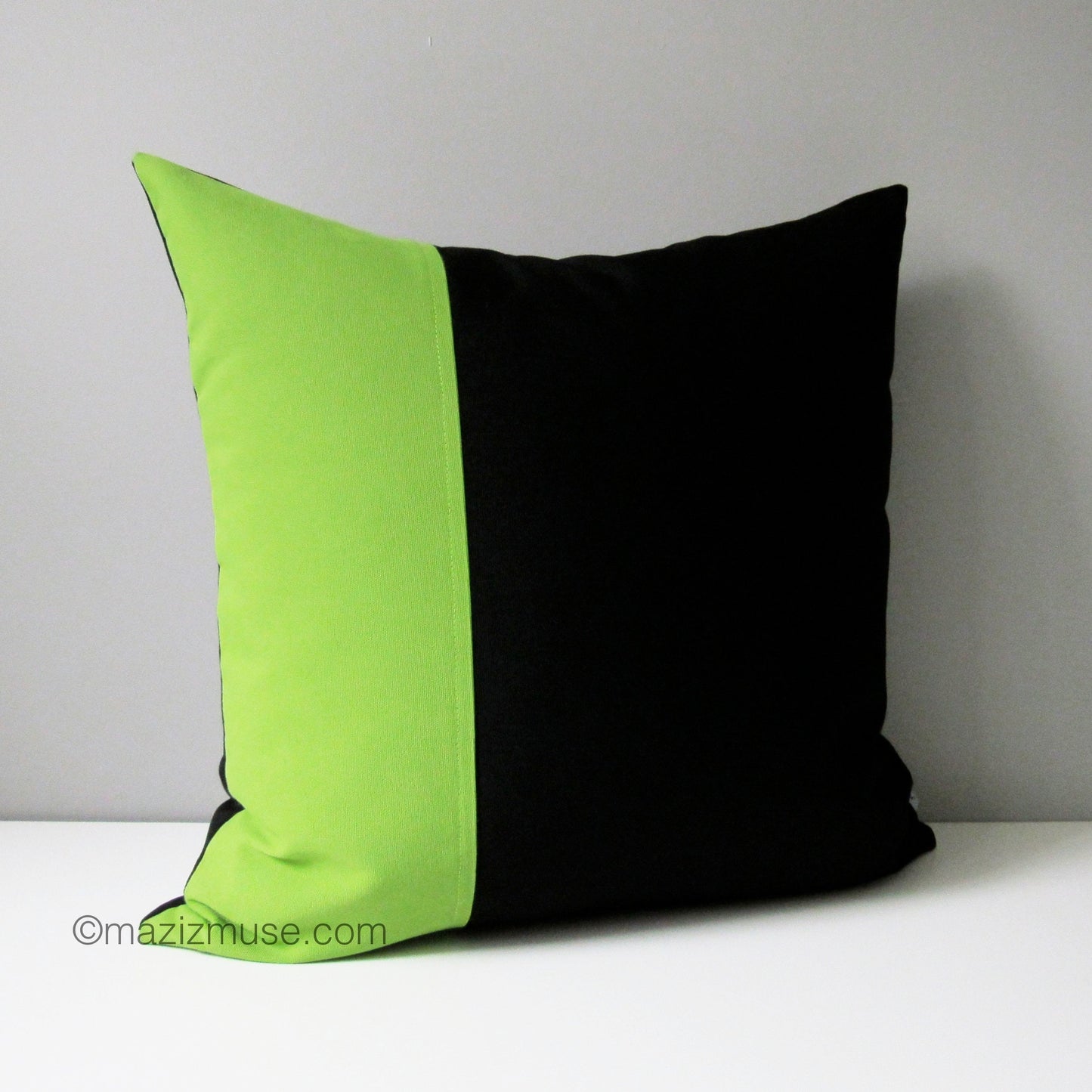 modern black and lime green outdoor pillow in sunbrella