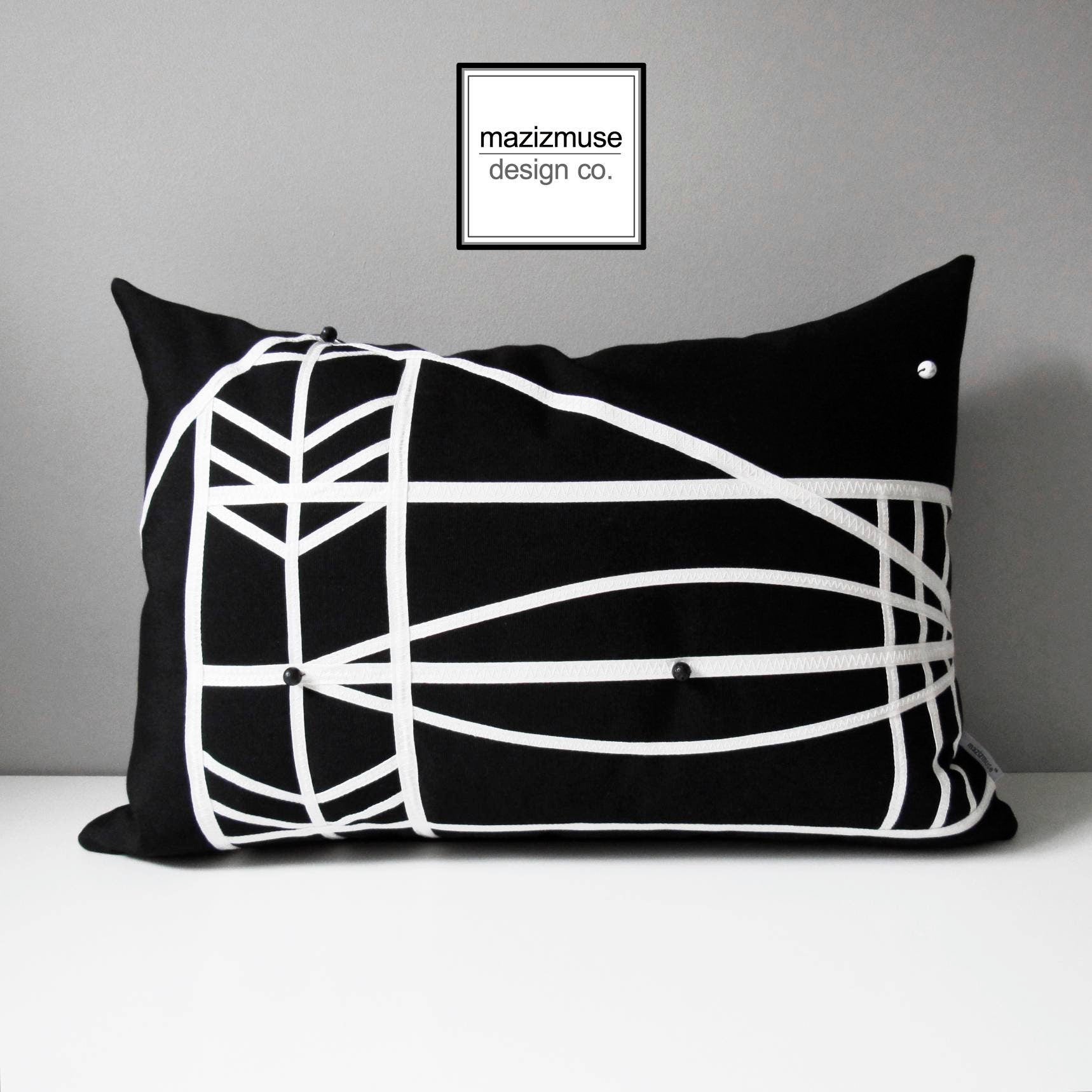 modern black and white outdoor pillow with trim detail and beading. inspired by micronesian explorers' ocean maps