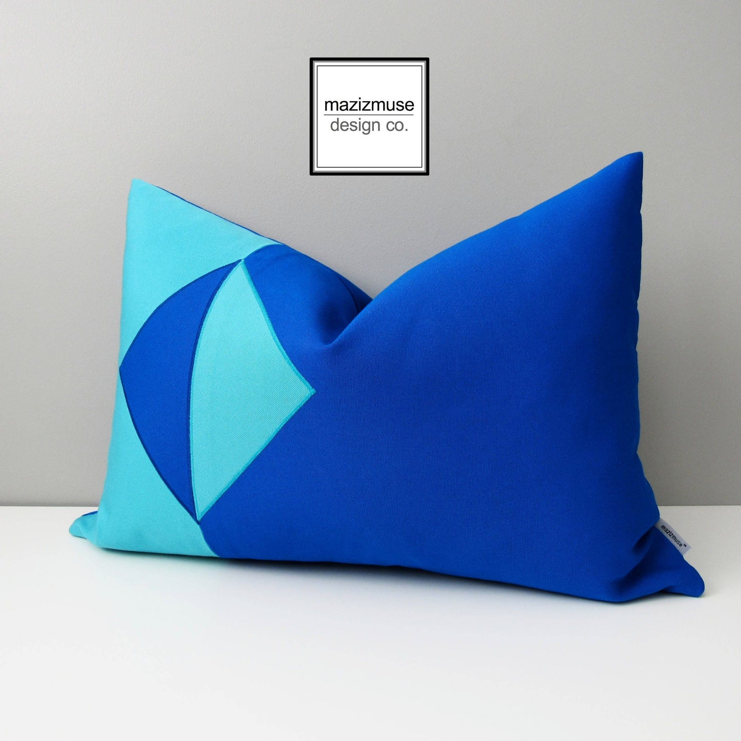 pacific blue and aruba blue sunbrella outdoor pillow cover with modern geometric inspired by an eclipse.
