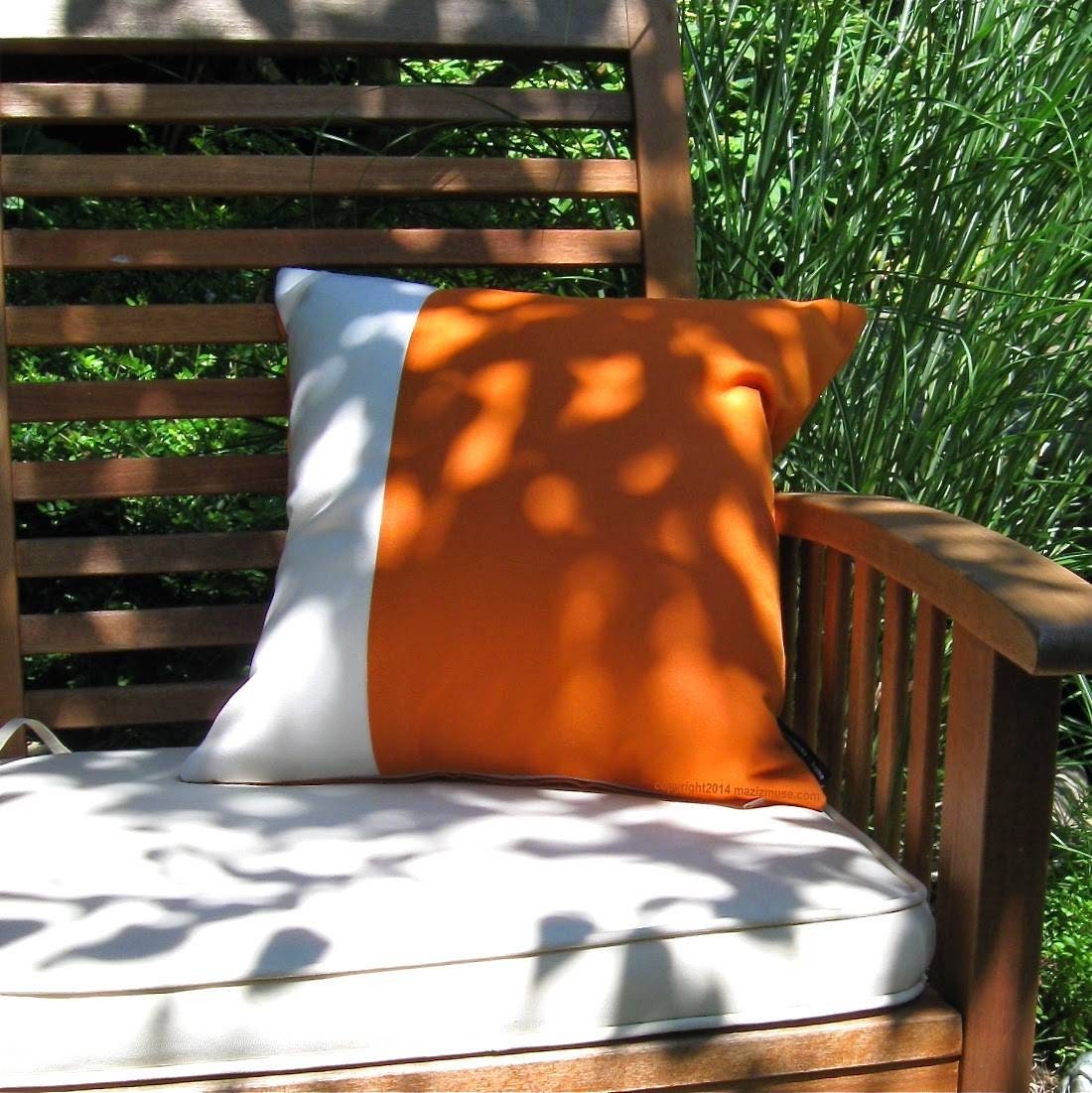 tuscan orange sunbrella pillow cover with white color block on deck chair
